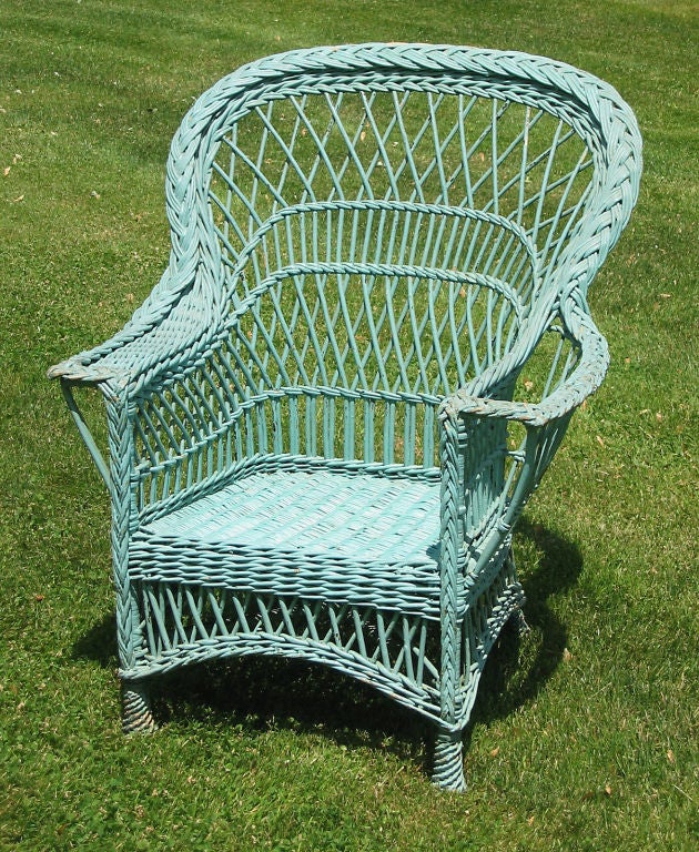 Unusual Bar Harbor style wicker armchair in appealing worn tealtone/aqua painted finish.  High backrest with broad shoulders.  Alternating diagonal latticed & vertical willow sections.  Magazine pocket woven into left arm, wide flat right arm. 