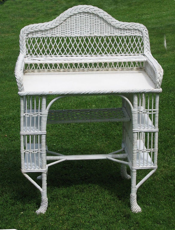 White Bar Harbor style wicker vanity/writing desk. Two open wood shelves on either side, wicker shelf above writing surface, decorative 46