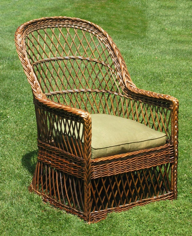 Bar Harbor wicker armchair in original natural stained finish as shown in the 1906 Gustav Stickley CRAFTSMAN WILLOW FURNITURE catalog. Traditional diagonal willow latticing overall, braided arms, latticed skirting to the floor on all 4 sides,