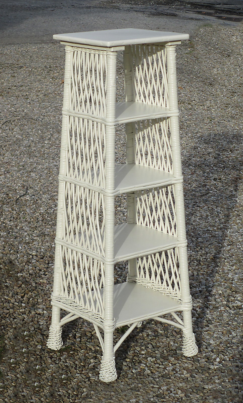 Bar Harbor style wicker shelf/etegere having wood top and four graduated shelves. Traditional Bar Harbor diagonal latticing on sides. Four twist-wrapped pineapple feet. White painted finish (can be re-painted any color on request).