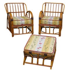 MATCHING PAIR OF RATTAN ARMCHAIRS WITH OTTOMAN