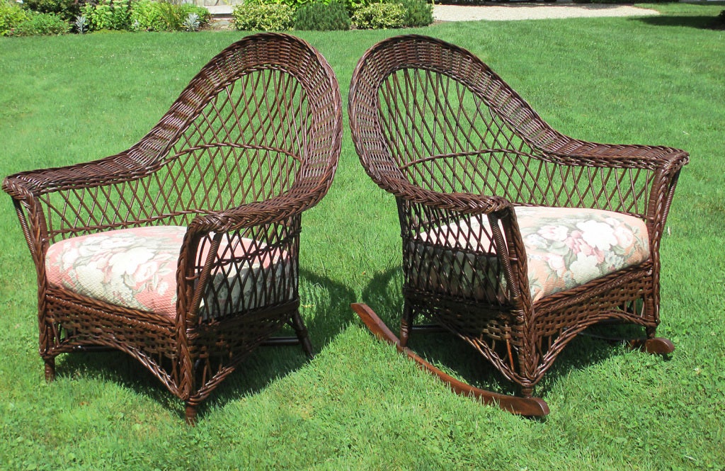 Bar Harbor wicker armchair and matching rocking chair in natural stained finish. Arched backs, wide flared arms, original box spring seats. Hallmark criss-crossed open reed latticing. Measurements as follows - chair: 33