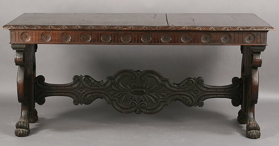 Antique Italian Renaissance style trestle base library table having a carved edge, ornate apron, figural base with scrolling ends and ornate stretcher.

Keywords:  Entry hall Table, refectory table, center hall table.