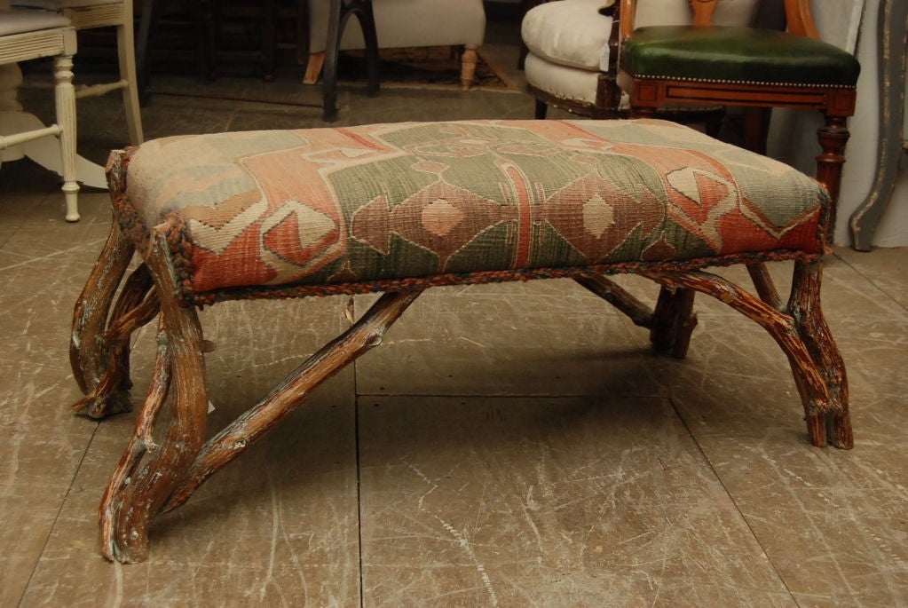 Rustic bench with legs made of natural wood and upholstered seat covered with killim carpet.  Legs of the bench sticks out further:  42 x 21