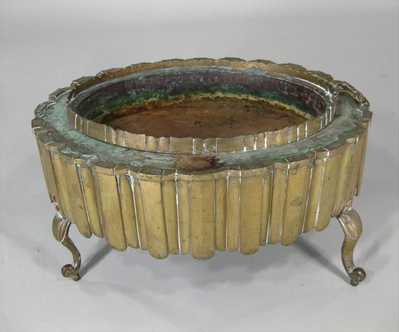 Oval Brass Brazier, probably Turkish, 19th C., with removable fire pan on a stand of scalloped outline with deep lambrequin skirt on cabriole and ball feet.