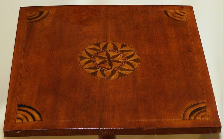 A decorative and rare Connecticut River Valley cherry table with possibly unique inlays made at the end of the 18th century. While the details of the form of this table are not unusual the inlay is from the individual imagination of the maker who