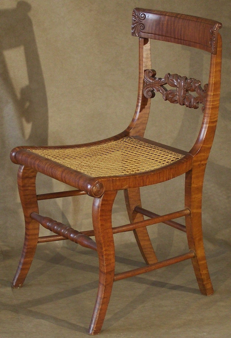 A very nice set of 4 Federal Period Pennsylvania side chairs made primarily from tiger maple, ash/hickory side and rear stretchers and hand woven cane seats. The back tablets have incised lines with leaf carving at each end. The central back splats