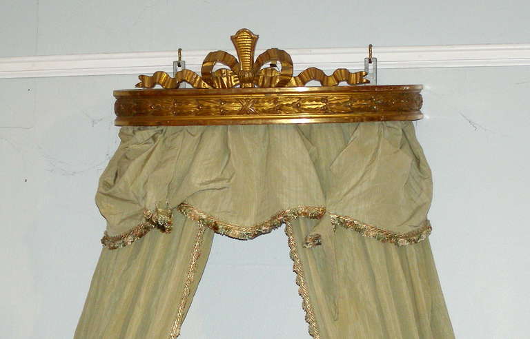 A nice decorative accent for the expression of the royal persona within you. 
This corona is made from carved and gold leafed wood and most likely of
European manufacture in the 2nd half of the 19th century. The hangings 
are included but they