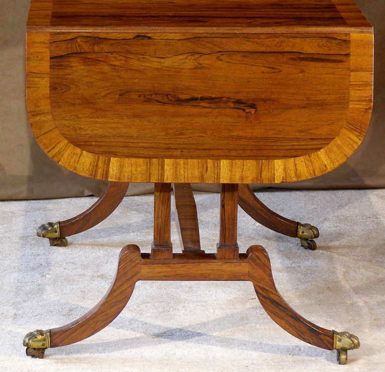 A very nice example from England, made in the 1st quarter of the 19th century. 
It is in remarkably good condition showing only the slight repairs to cross-banded elements. The finish is low luster. There is a single drawer on one side that has red