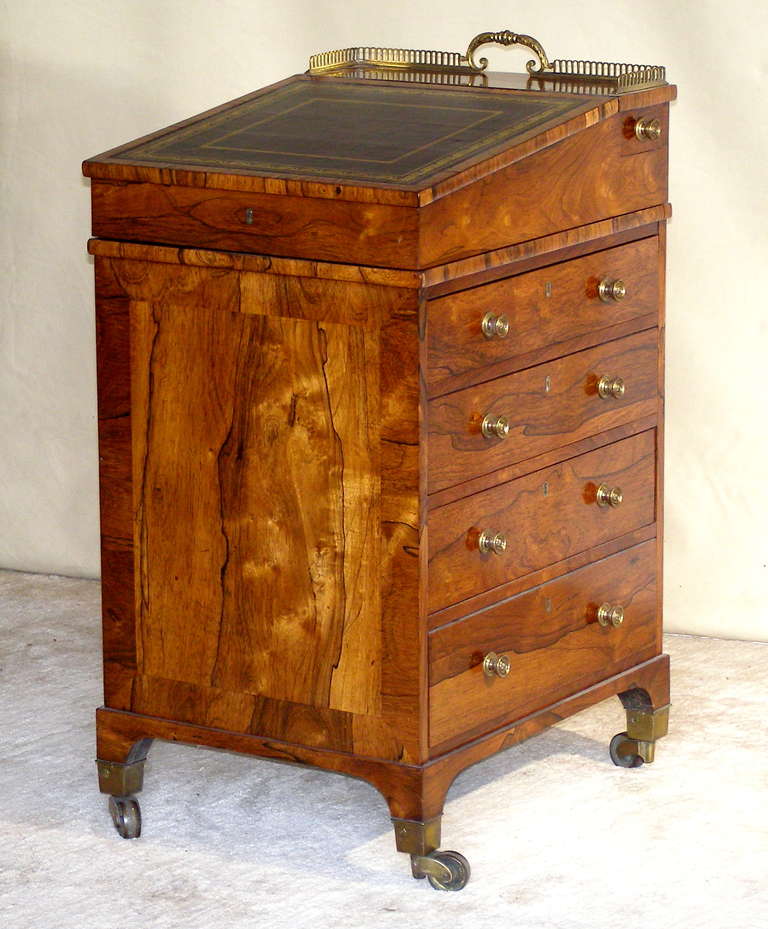A beautiful example of the earliest form of a Davenport Desk in a very small size. The exquisite amber and black Brazilian Rosewood combine with perfection in cabinet making skills make this a prize for any collection. It has a gold tooled inset