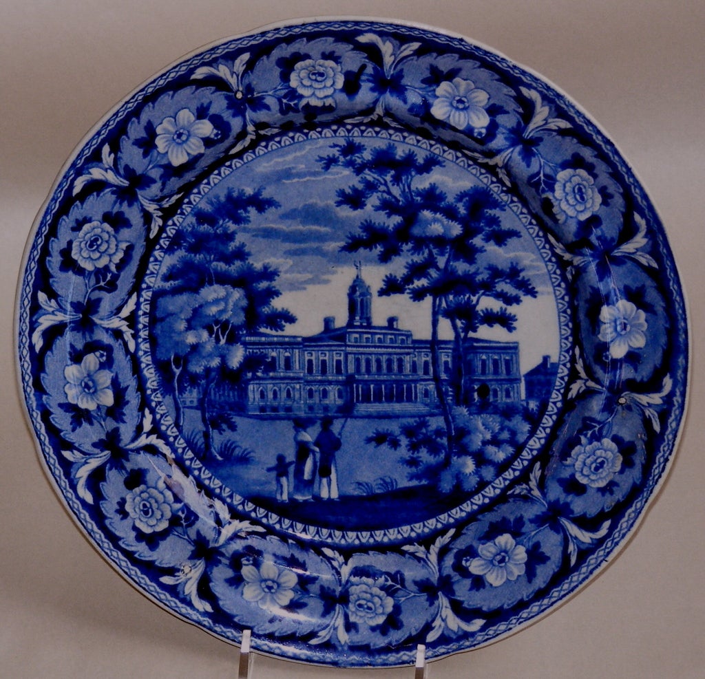 A medium dark blue Staffordshire transfer ware plate depicting a grand view of New York\'s city hall. New York\'s population was mushrooming when this still standing example of Georgian Architecture was begun in 1810. It was a time when the