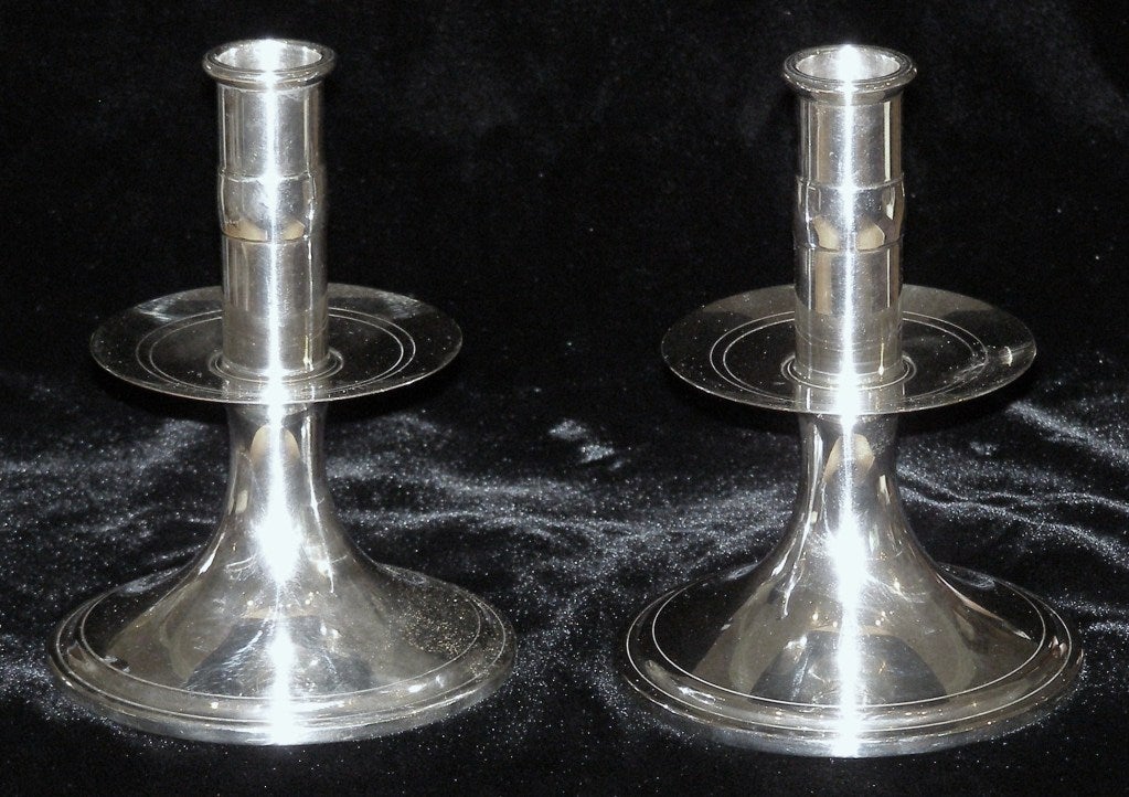 This pair of Sterling sticks were manufactured by Tuttle Silversmiths of Boston, a company associated with copies of antique silver designs. This pair indicates it is in the Gov. Winslow pattern named for Governor Edward Wislow of the Early Plymouth