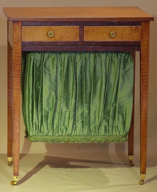 A very fine high style country side table that works well as a regular two drawer side table or with the pleated compartment for madam's sewing. This was purchased from Berry Tracy (1933-1984), a former curator of the Metropolitan Museum of Art's