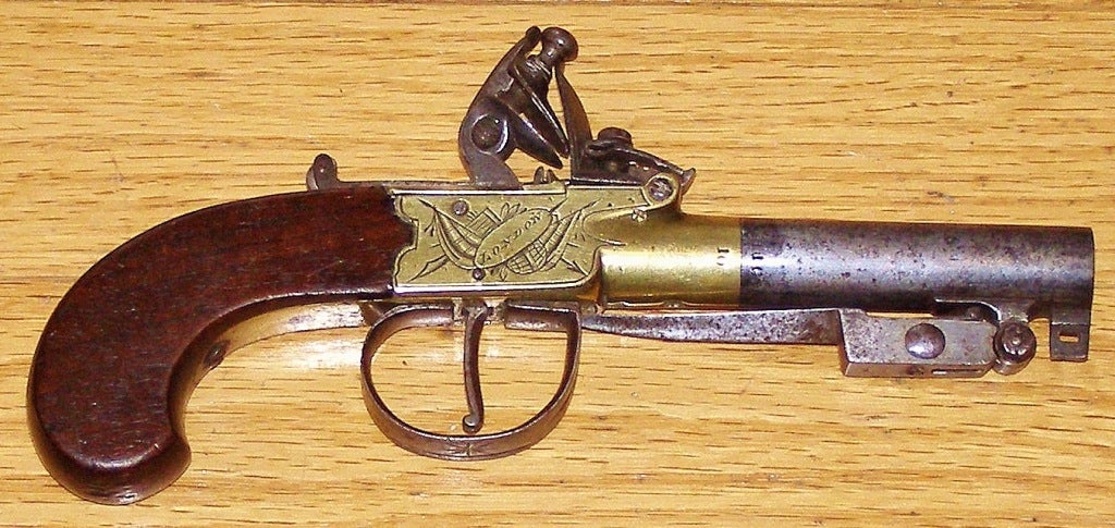 Perfect for pocket or purse and if you miss with your one shot you
can flip out the little spring loaded bayonet by pulling back on the trigger guard. Pistols like this were made in the late 18th and early 19th century. The brass is engraved on each
