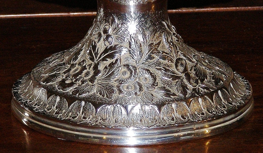 A fine quality sterling or coin silver pedestal bowl made by Samuel Kirk & Son with barely an undecorated  area on it. The maker, Samuel Kirk, opened for business in 1815 and by 1828 had fully developed his intricate engraved and repousse' designs