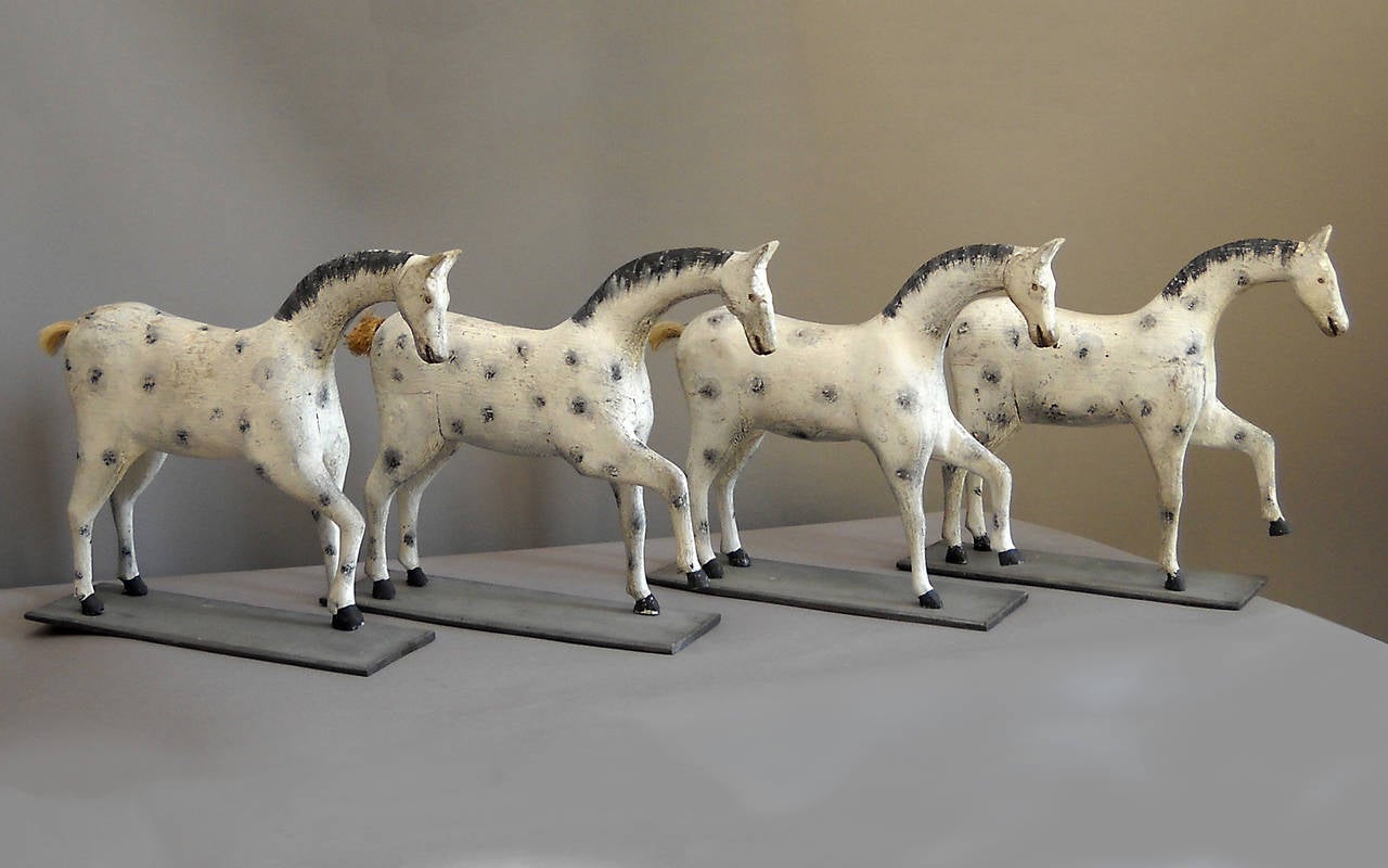 Four carved toy horses by Ewald Person of Malmö, Sweden, circa 1910. These were made for Person's grandchildren and are quite similar, perhaps in the hope that the children wouldn't fight over them. Still, each horse has its own personality with