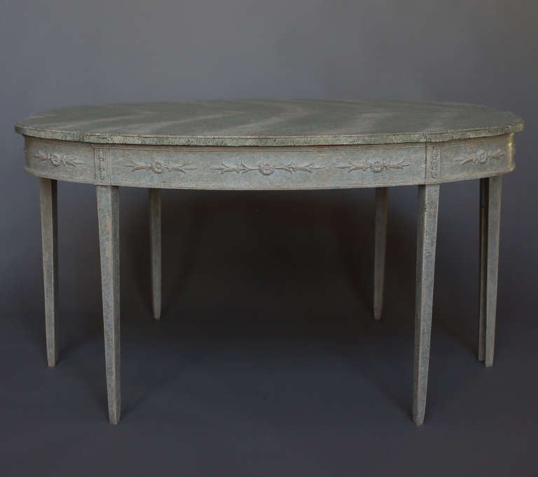 Rare pair of period Gustavian console tables, Sweden circa 1780, with marbelized tops. Wide aprons are decorated with applied floral carvings. Simple, tapering legs and original paint, including the marbelized tops.