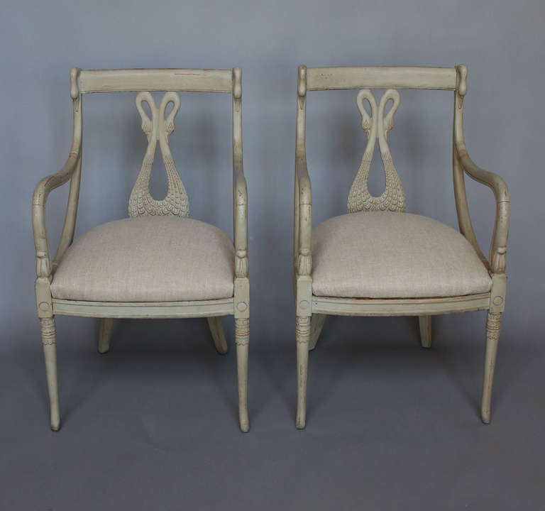 Pair of armchairs, Sweden circa 1860, with swan carved splats and gracefully curving arms with swan heads at the top. Interesting detail on the legs.