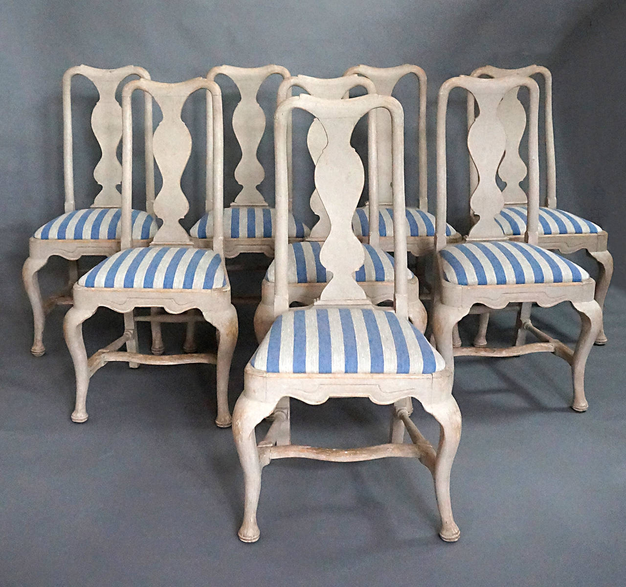 Set of eight dining chairs in the Rococo style, Sweden, circa 1900. Curved fiddle backs, cabriole front legs and H-shaped stretchers. The slip seats are newly upholstered in linen.