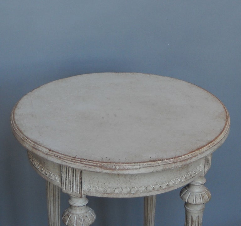 Pair of small round tables in the Gustavian style, Sweden circa 1900, with saltire stretchers and centering urns.
