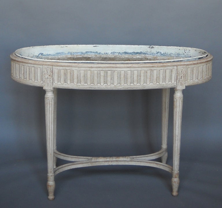 Swedish jardinière, circa 1910, in the Gustavian style and retaining its original tin liner. Curved stretcher with carved detail.