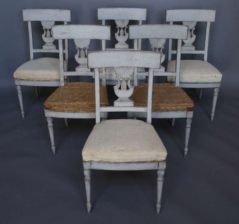 Set of six dining chairs, Sweden circa 1860, with splats showing the influence of the Egyptian revival. Curved tablet backs and elongated bulb feet at the front. Very comfortable.