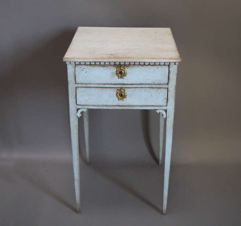 Ladies work table, Sweden circa 1840, in pale blue paint. Two drawers, the top one divided, dentil molding,and straight, tapering legs. A charming small table.