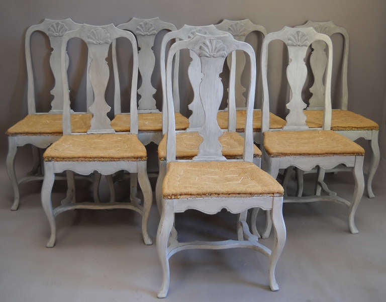 Set of eight Swedish dining chairs, circa 1880, in the rococo style with shaped splat and stretcher. Cabriole legs and curved H-shaped stretchers.