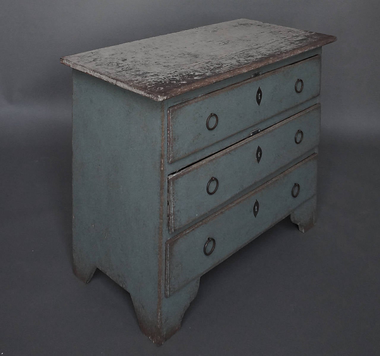 Period Swedish chest of drawers in blue paint, circa 1800. Simple form with shaped bracket base.