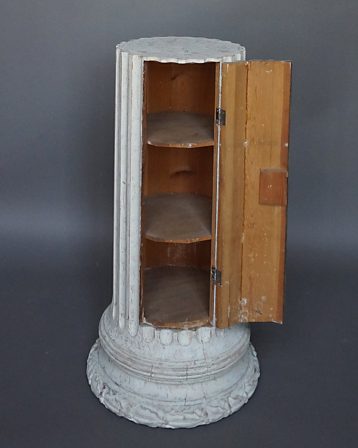 Neoclassical columnar cabinet, Sweden, circa 1860, with two interior shelves. Laurel leaf and berry frieze surrounds the base.