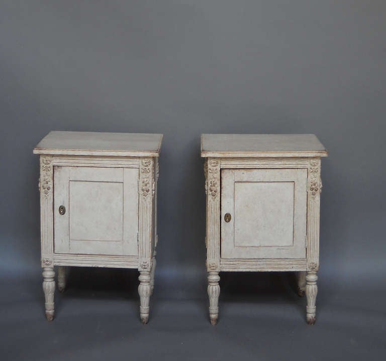 Pair of nightstands, Sweden circa 1910, in the Gustavian style with garlands of fruit at the corners and carved, bulbous legs. From a private collection.