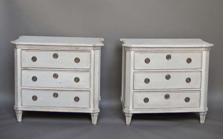 Pair of commodes in the Gustavian Style, Sweden, circa 1870. Shaped tops, canted corners, and dentil molding. Brass hardware.