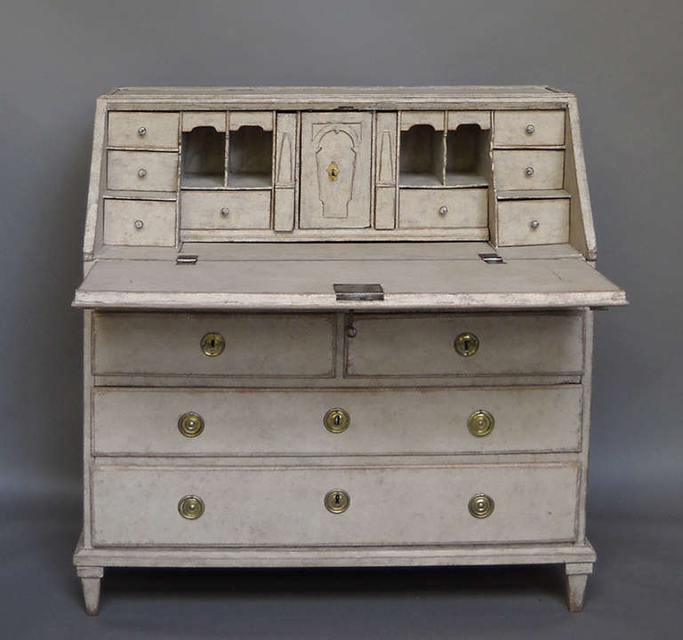 Swedish slant front writing desk, circa 1780, with fitted interior with two over two drawers below.

The interior features a number of disguised drawers and an unusual sliding panel giving access to a concealed storage area behind the shallow
