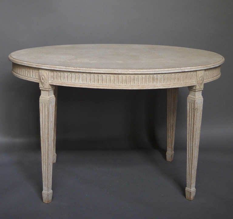 Small oval dining table in the Gustavian style, Sweden circa 1900. Reeded apron and legs with applied rosettes where the legs and apron join.