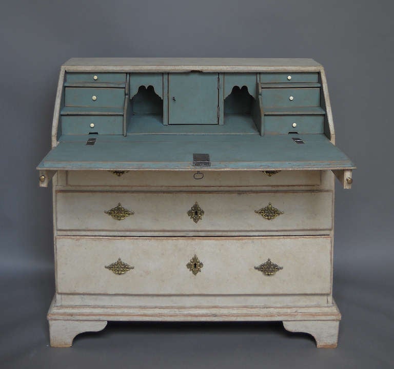 Period Swedish slant front writing desk, circa 1780, with blue fitted interior. Three lower drawers have elaborately cast brass pulls with angels supporting the Swedish royal crown.