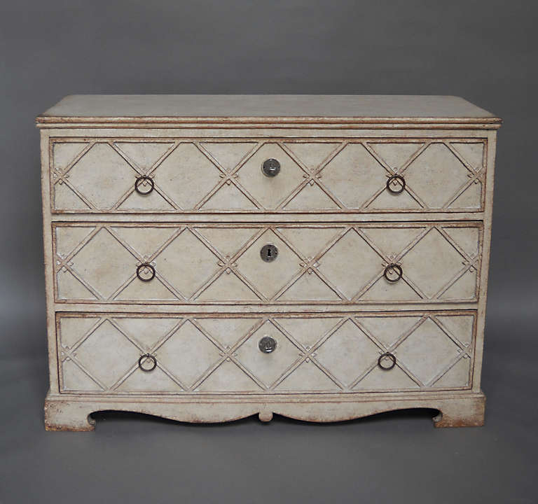 Chest of drawers, Sweden circa 1850, with a raided lattice pattern across the drawer fronts. Iron hardware and shaped bracket base.