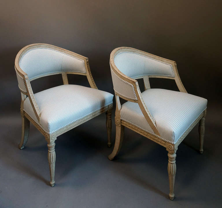 Pair of Gustavian style armchairs, Sweden circa 1900, with barrel backs and beautifully carved frames. Newly upholstered in cotton check with double welt trim.