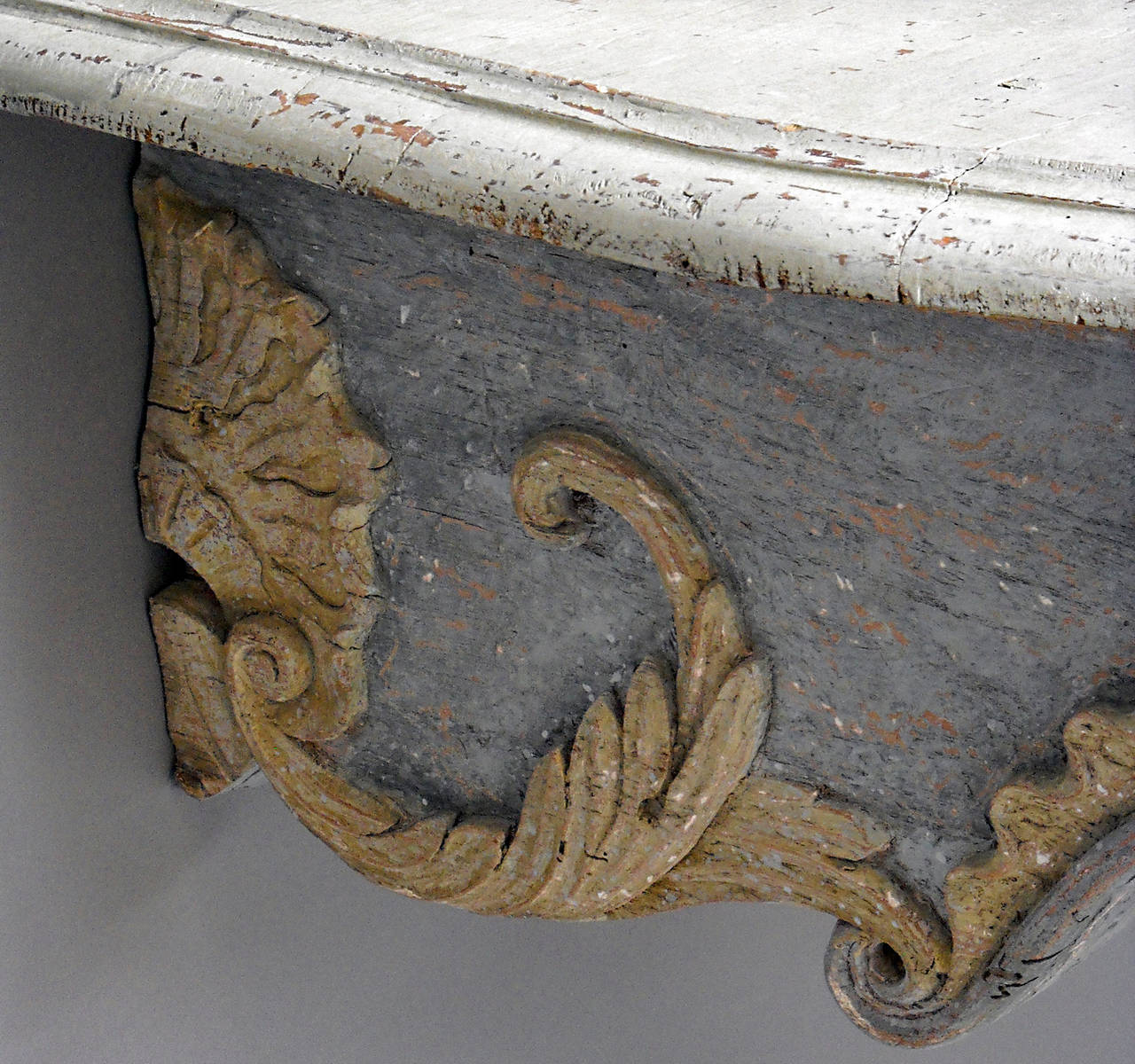 Beautifully detailed Baroque console table, Italy circa 1750, in original paint. Bold foliate scroll legs flanking an apron carved with rocaille decoration.