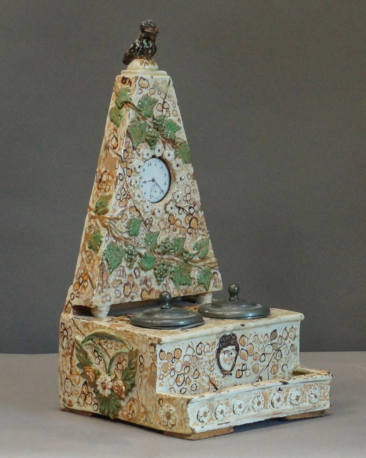 Scholar's earthenware inkwell and watch stand, Germany, circa 1780. Neoclassical details include the relief portrait of Athena and on the base and the owl finial. Opening in the back holds a pocket watch. Excellent condition with no repairs.