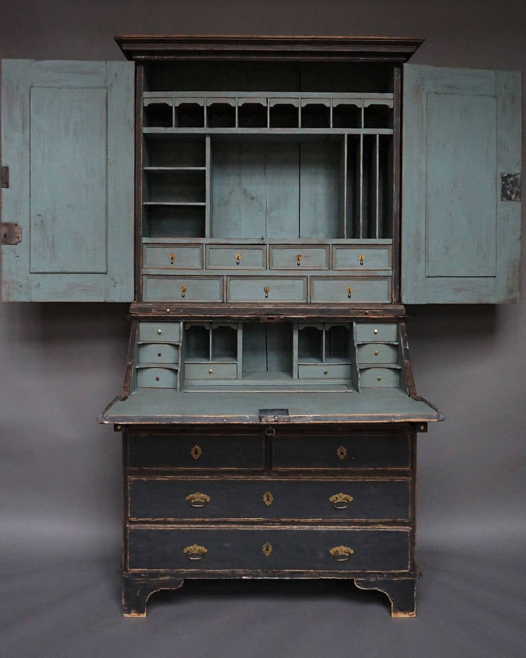 Period baroque secretary in two parts with elaborately fitted interior, Sweden circa 1750.The upper section, in addition to its drawers and compartments, has two candle slides in its base.

The lower section has a slant front above a narrow pencil
