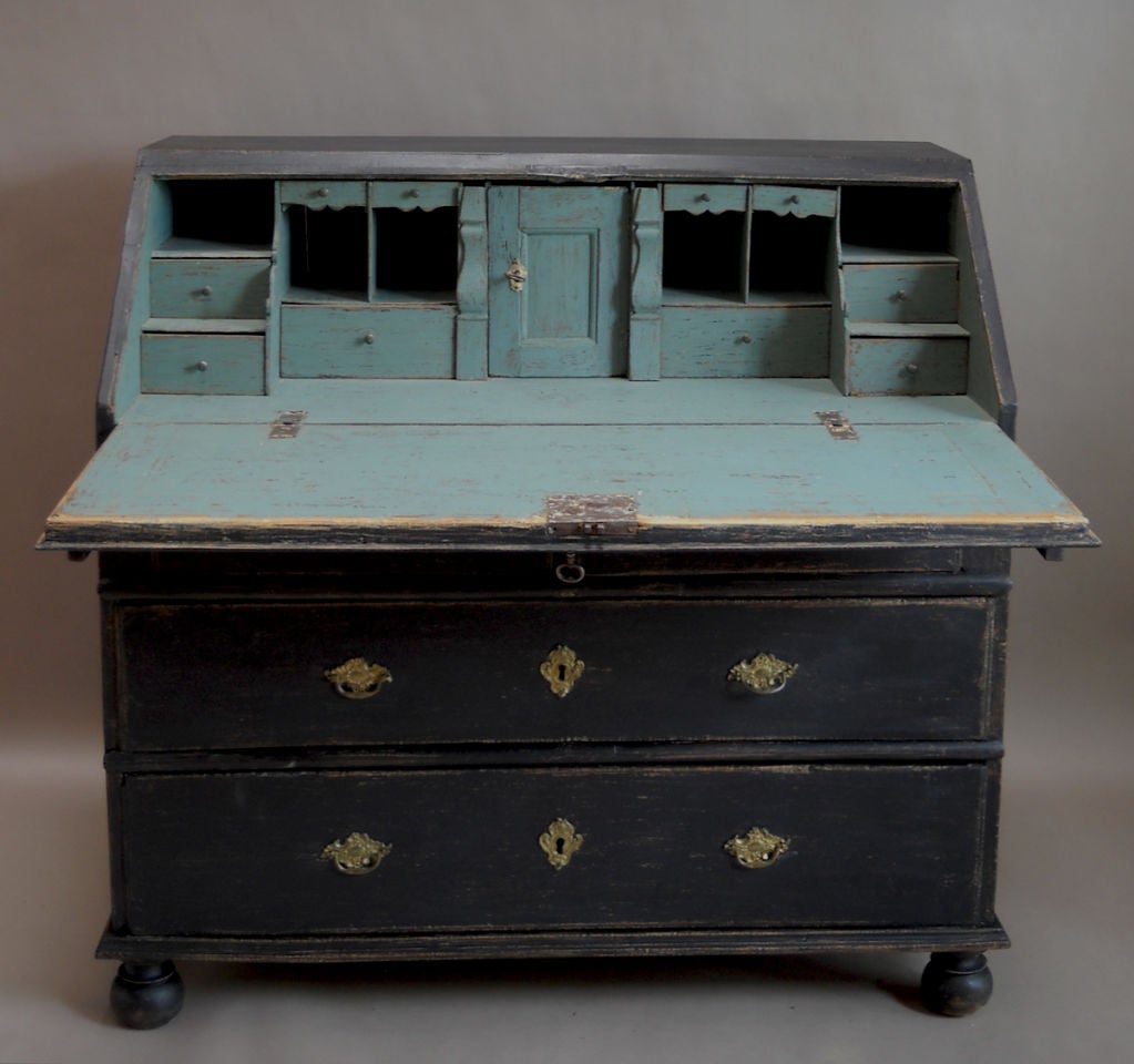 Black painted writing desk, Sweden circa 1760 with slant front and two over two drawers. The interior in blue paint has multiple drawers and cubbies, with two hidden compartments. Simple bun feet. (Depth when open is 34