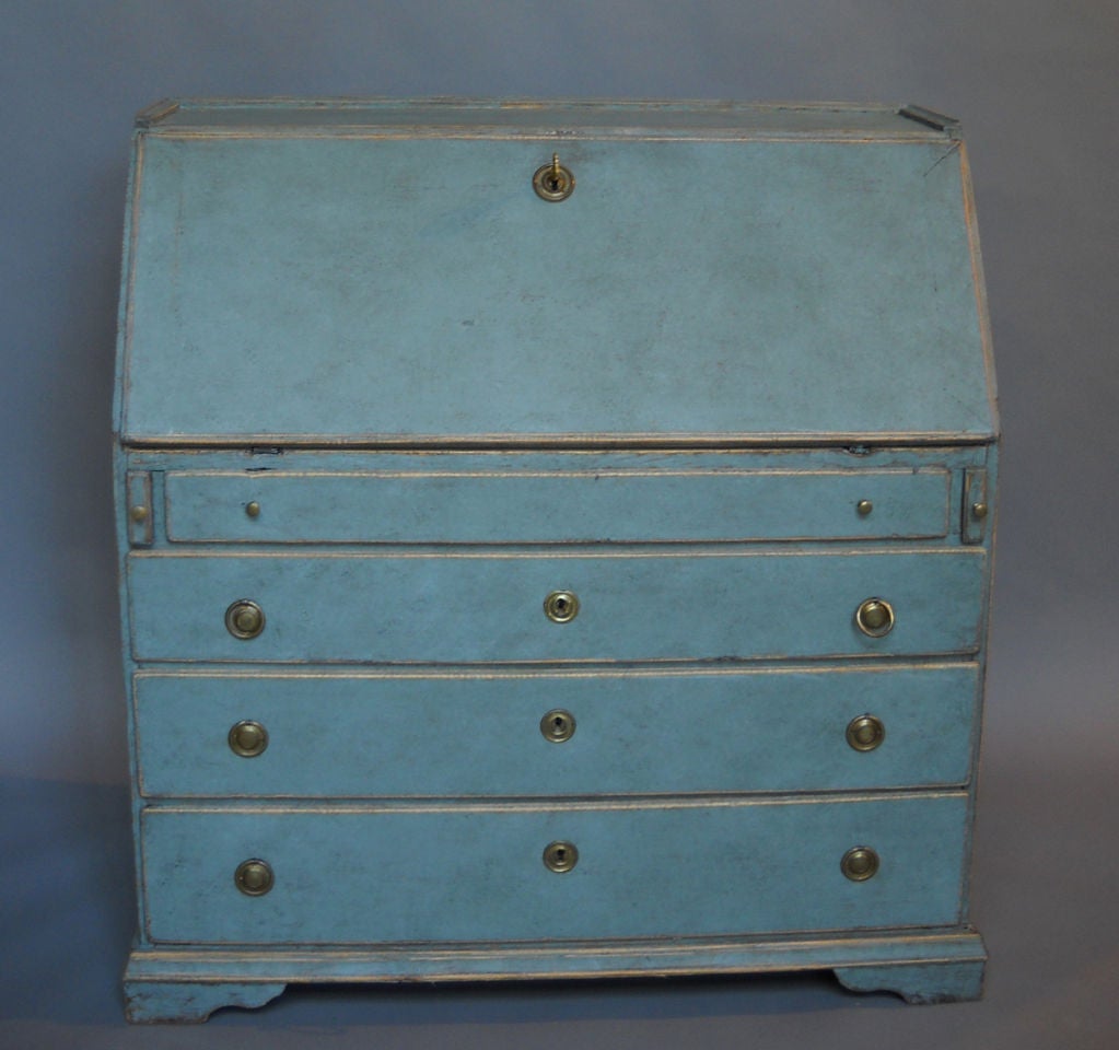 Swedish writing desk, circa 1820, with four graduated drawers under the slant-front. The interior features a central cupboard with lozenge trim and two banks of three drawers on either side. Great patina on the secondary blue paint.