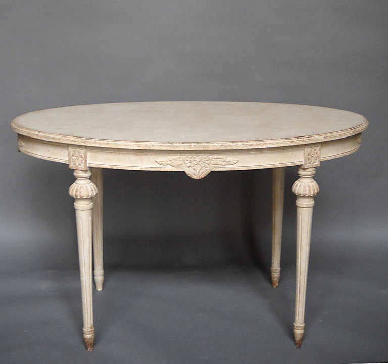 Oval Swedish side table, circa 1910, in the Gustavian style. Floral sprays on the apron, as well as rosettes at the top of each leg.