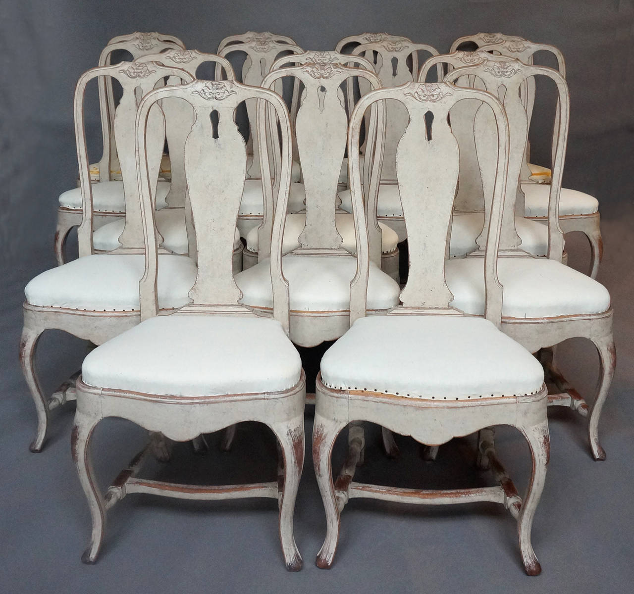 Set of 16 Swedish dining chairs, circa 1900, from the old Hotell Höjden in the islands east of Stockholm. Rococo style with cabriole legs, pierced splats with carved detail, slip seats and H-shaped stretchers.