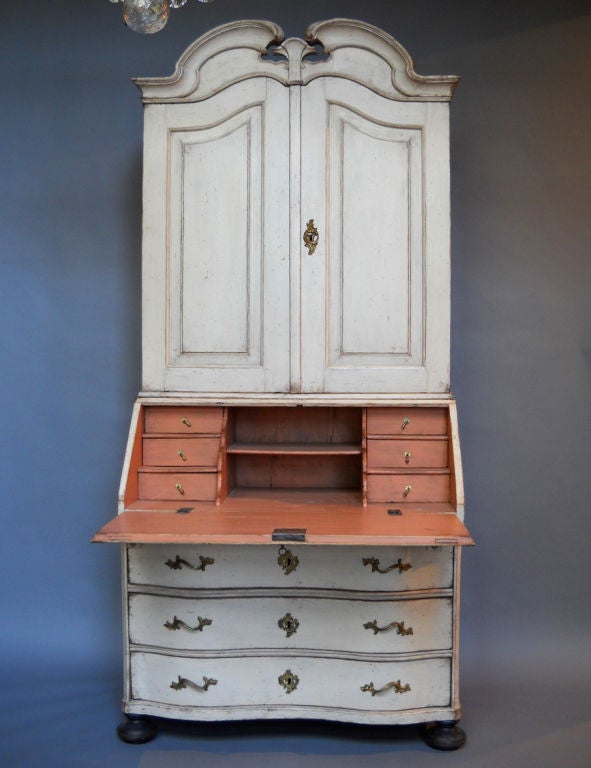 Swedish secretary, circa 1750, with broken pediment cornice. The top, or library, section has raised panel doors with shelves and drawers behind, as well as a larger space, perhaps for a clock or folio volumes. The lower section has three bow front