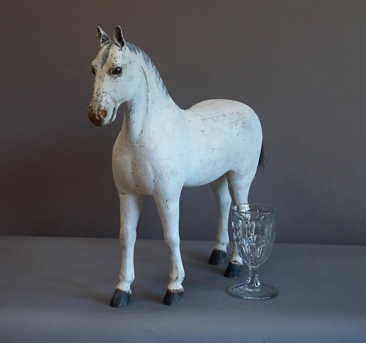 Carved Swedish horse, circa 1910, with docked horsehair tail. The mane is painted and the ears are leather. Glass eyes and original painted surface.