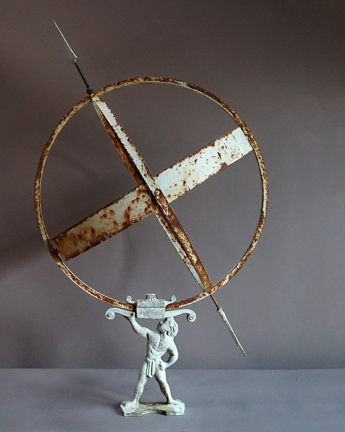 Swedish armillary sundial, circa 1900, supported by a neoclassical figure. Iron construction with copper hour band inside the celestial equator ring.