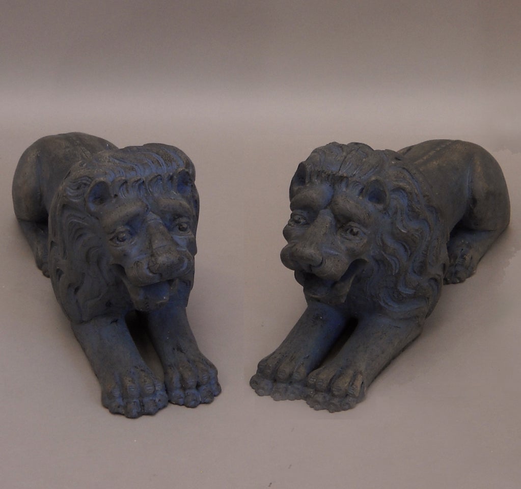 Pair of lions couchant, Sweden circa 1820, carved of wood and retaining traces of their original blue paint. Wonderfully expressive faces.