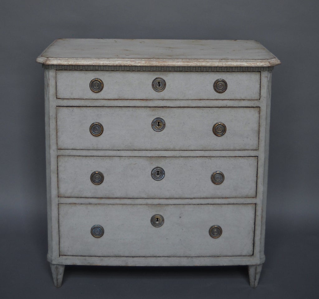 Gustavian style chest with four graduated drawers, Sweden circa 1860. Dentil molding at the top and canted corners with applied lozenges. Brass hardware.