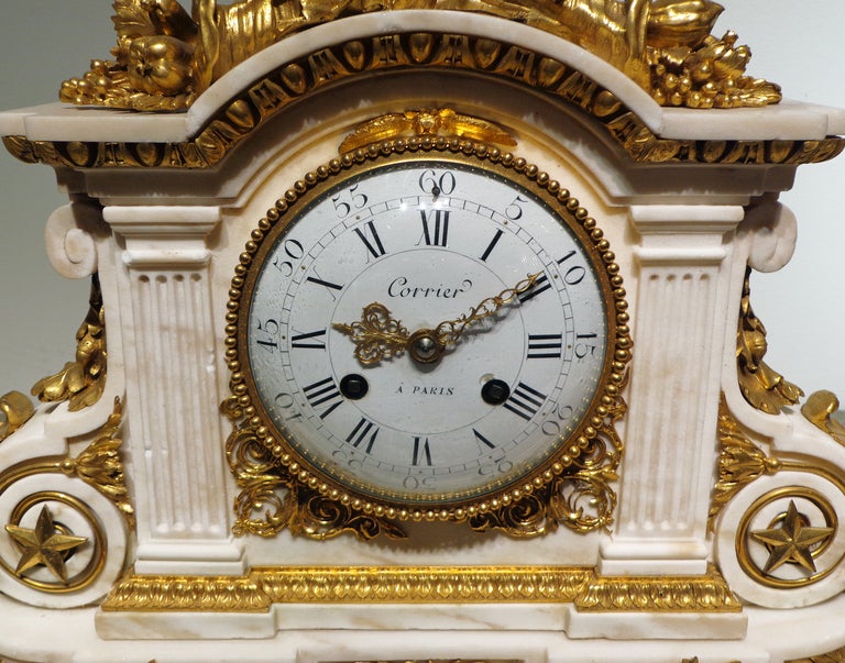 A Fine Louis XVI
 Marble & Gilt Bronze Clock 
18th Century 
Signed Corrier A Paris 

A large Louis XVI ormolu French clock by Corrier à Paris. The symmetrical case has numerous bronze mounts that including a large floral motif with two